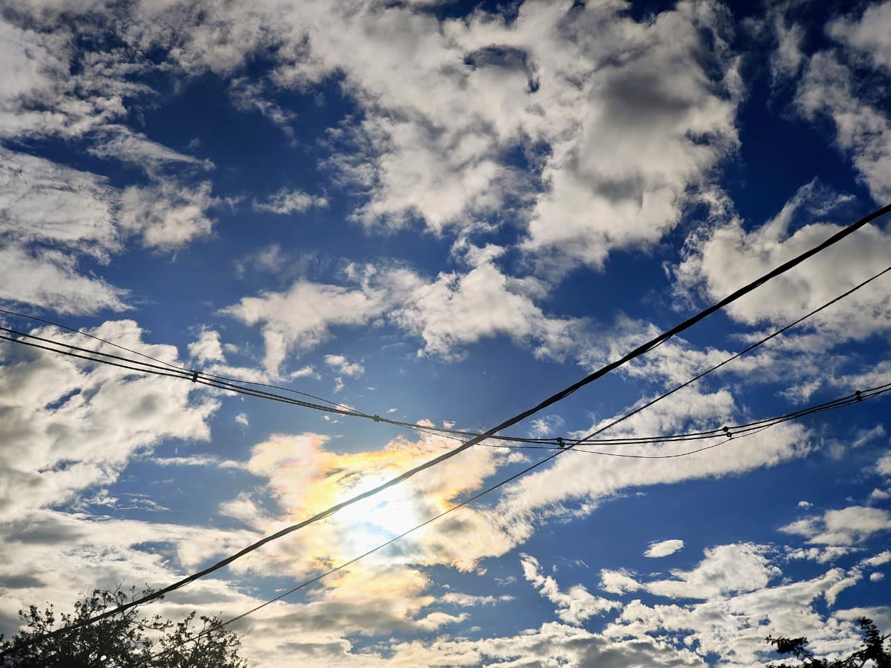 Minimalist urban sunset by Fresnel, featuring power lines framing a glowing sun in Bengaluru.